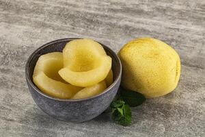 A bowl of peeled peaches and a bowl of sliced peaches photo
