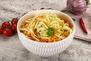 A bowl of salad with carrots and onions photo