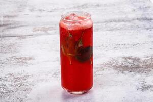 A red drink with a straw in it photo