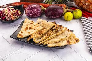 A plate of food with tortillas, vegetables and fruit photo