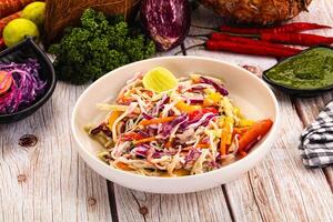 A bowl of salad with vegetables and other ingredients photo