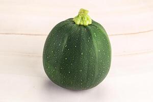 A green squash on a white background photo