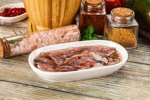 A bowl of meat and spices on a table photo