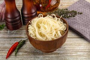 A bowl of noodles with spices and other ingredients photo