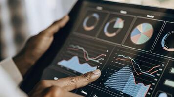 A detailed shot of a holographic interface showcasing a realtime data analytics dashboard complete with colorful pie charts and line graphs while a user taps on the screen with. photo