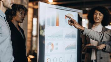 A holographic display showcasing a live comparison of resource allocation across multiple projects with a user discussing insights and trends with colleagues in the background.. photo