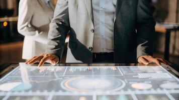 An individual in a sharp suit standing confidently before a holographic dashboard with a 3D pie chart rotating slowly and financial indicators pulsing in vibrant colors.. photo