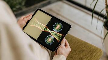 Zoomedin holographic visualization of a cell nucleus with dynamic movements revealing chromosomes enveloped in a digital interface displaying gene interactions.. photo