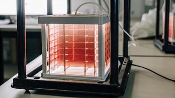 A compact bioreactor glows softly while cultivating microbial cultures on its internal sensors emphasizing the controlled environment that biohackers create for experimentation and. photo