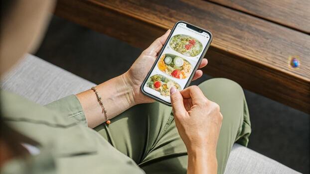 An individual using a smartphone app to input dietary choices with a focus on colorful meal options being analyzed for nutritional content highlighting the fusion of technology and. photo