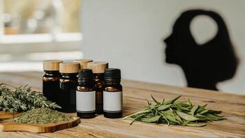 A display of assorted natural supplements on a wooden table with a human silhouette in the background engaged in deep thought depicting the exploration of cognitive optimization. photo