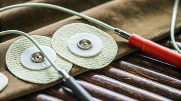 Closeup of electrodes designed for neurostimulation showcasing their delicate construction and flexible dial feature that allows adjustment for optimal contact with the scalp.. photo