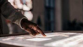 A closeup of a hand reaching towards a holographic display illuminating a specific market segment in vibrant colors highlighting userfriendliness and accessibility of the. photo