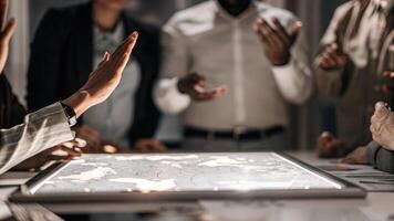 A group brainstorming around a table hands raised in discussion with a large holographic map revealing market insights and competitive analysis hovering above them.. photo