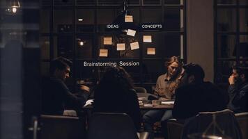 A small team is engaged in a brainstorming session with holographic postit notes floating above the table each projecting different ideas and concepts in a collaborative. photo