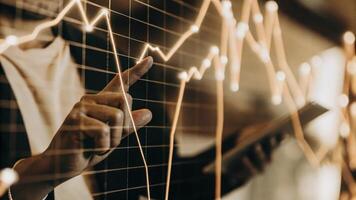 Closeup of a hologram displaying interconnected financial data points with animated lines suggesting trends and correlations as a focused analyst traces the patterns with a finger.. photo