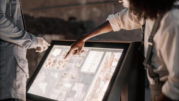 A technician is interacting with a virtual holographic interface that simulates a supply chain disruption with moving parts representing different elements while he devises a. photo