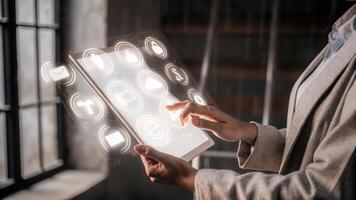 A focused user interacting with a holographic productivity tracker as icons and metrics swirl elegantly around their hand exhibiting seamless technology.. photo