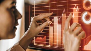 A focused individual manipulates a holographic simulation of business metrics with dynamic analytics visually responding to their adjustments representing realtime data analysis.. photo