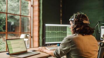 An interactive scene depicting a user in a busy workspace casually wearing an EEG headset while data flows seamlessly to a laptop reflecting onthego brainwave analysis.. photo