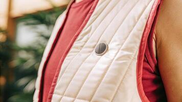 An intelligent fabric vest embedded with biometric sensors capturing muscle activity and heart rate with a focus on the texture of the material and the seamless integration of. photo