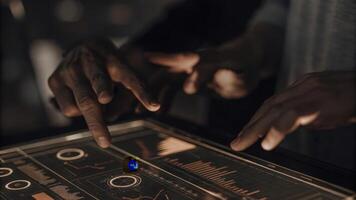 A closeup view of hands interacting with a holographic touchscreen interface with colorful icons and data charts projected in midair showcasing user engagement with futuristic. photo