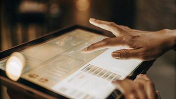 A closeup of two fingers tapping on a floating holographic interface revealing detailed product information and shipping statuses in a vibrant translucent display.. photo