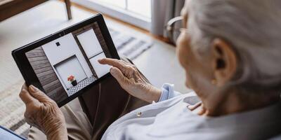 A closeup of an elderly patients face illuminated by soft lighting as they concentrate on augmented reality instructions displayed in front of them highlighting their determination. photo