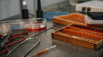 A closeup of a laboratory workstation cluttered with pipettes Petri dishes and genomic sequencing tools reflecting the environment where selfexperimentation takes place.. photo