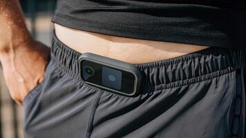 A closeup examination of fitnessfocused shorts showcasing a digital display integrated into the waistband that provides workout summaries and health metrics without a bulky form. photo