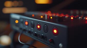 Professional audio mixer with illuminated buttons and knobs in operation photo