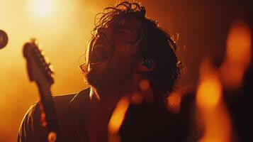 A dynamic shot of a lead singer passionately belting out a song with the camera focused on their electrifying presence while the audience is faintly visible their hands raised in photo