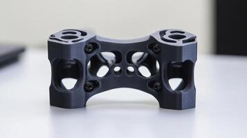 A detailed view of a custom 3Dprinted gimbal bracket featuring complex geometries that provide stability while maintaining minimal weight with visible layering that emphasizes the additiv photo