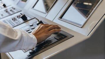 Closeup of an individuals hand manipulating a sleek control panel for an advanced cognitive training machine with lights and screens illuminating their determination to enhance. photo