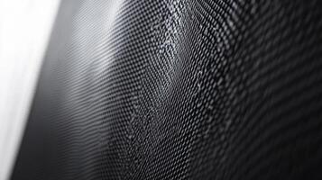 Wavy black grid reflecting light creating abstract pattern photo