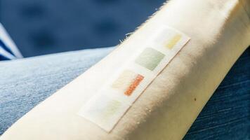A macro image of skin with embedded colorchanging tattoos that react to emotions enhancing the sense of awareness and communication through visual expressions tied to biofeedback. photo