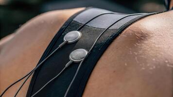 A macro shot of skin sensors adhered to an athletes back tracking muscle recovery metrics and fatigue levels through biofeedback.. photo