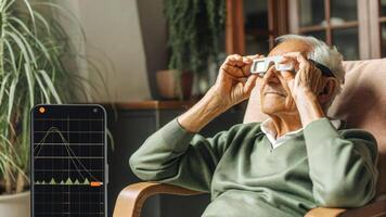 An elderly man sitting in a comfortable chair adjusting the settings on his augmented reality glasses as he views a realtime chart of his sleep quality alongside animated tips for. photo