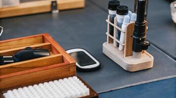 A mini lab setup on a table featuring a glucose monitor a glucometer and sample containers illustrating advanced tracking techniques for personal health management.. photo