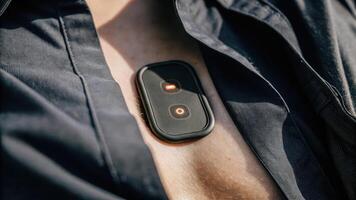 A personal health monitoring device embedded within the skin of a chest showing glowing indicators that analyze vital signs with synthetic cells visibly processing data beneath the. photo