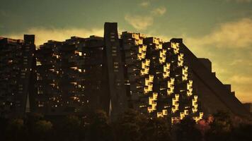 Sunset illuminates unique architectural structure in a serene landscape video