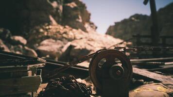 Detailed view of a rusty pulley system at a mining site in a rugged landscape video