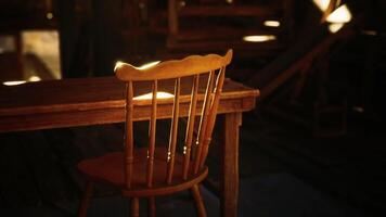 Sunlit wooden chair and table in a rustic indoor setting during the afternoon video