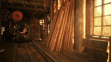 Sunlight streaming through a workshop window illuminating stacks of lumber video