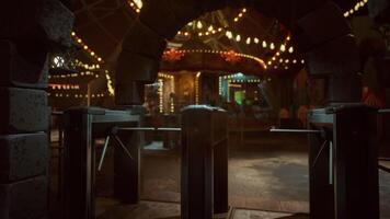Empty amusement park at night with illuminated attractions and closed gates video