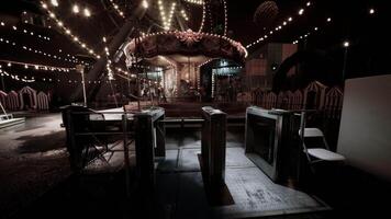 Empty amusement park at night with illuminated attractions and quiet pathways video