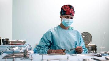A medical worker prepares instruments before surgery. Careful preparation and precision, reflecting the importance of each step before a surgical procedure. Perfect for medical projects. video