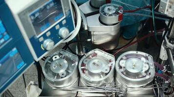 An overhead view of a working circulatory machine in the operating room during heart surgery video