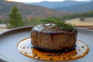 Gourmet Fillet Mignon with Rosemary Garnish in Scenic Mountain Setting - Perfect for Restaurant Menu Design photo