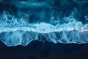 Aerial View of Ocean Waves Crashing on a Sandy Beach at Dusk for Coastal Design photo